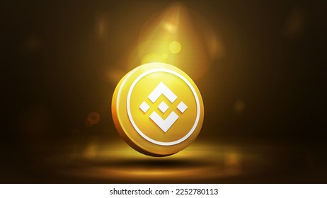 Gold binance 3d coin icon on a dark gold blurred background.