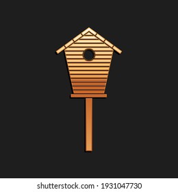 Gold Bird house icon isolated on black background. Nesting box birdhouse, homemade building for birds. Long shadow style. Vector