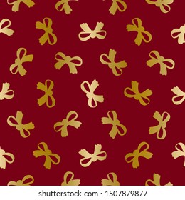 Gold bows on dark red vector seamless pattern