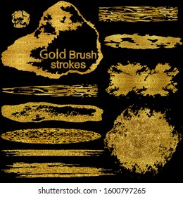 Gold brush stroke paint set isolated on black background