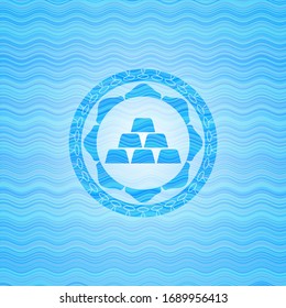 gold bullion icon inside light blue water wave badge.