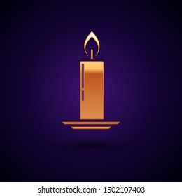 Gold Burning candle in candlestick icon isolated on dark blue background. Old fashioned lit candle. Cylindrical candle stick with burning flame.  Vector Illustration
