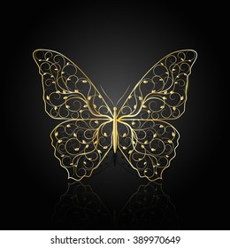 Gold butterfly with floral pattern on dark background with reflection.