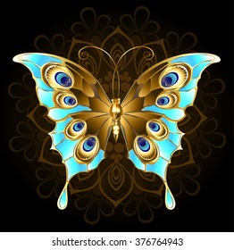 Gold, butterfly jewelry, decorated with turquoise on black background. 