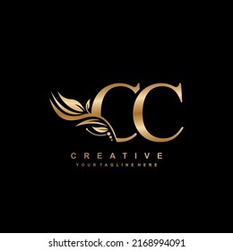 gold CC letter logo design with luxurious and beautiful leaf ornament. CC Monogram. typography. gold feather logo. initial letter logo. suitable for business logo, hotel, boutique, wedding, etc