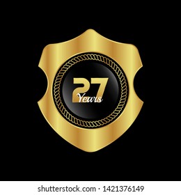 Gold celebration shield. 27 years anniversary