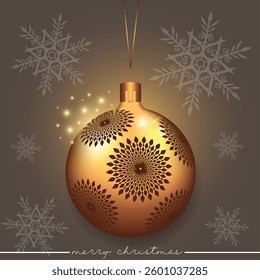 A gold Christmas ball with decorative flowers on a festive snowflake backdrop.