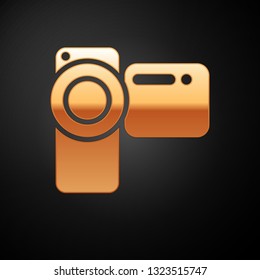 Gold Cinema camera icon isolated on black background. Video camera. Movie sign. Film projector. Vector Illustration