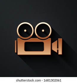 Gold Cinema camera icon isolated on black background. Video camera. Movie sign. Film projector. Long shadow style. Vector Illustration