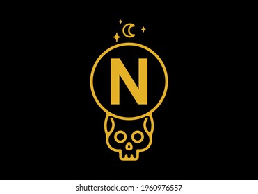 Gold color on dark background of N initial letter in skull circle