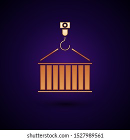 Gold Container on crane icon isolated on dark blue background. Crane lifts a container with cargo.  Vector Illustration