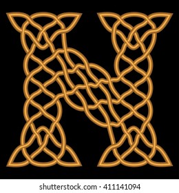 Gold or copper retro letter N is shown in a rich historic Gothic, Celtic and Arabic, oriental style with patterns, weaves, knots and ornaments on a black background.
