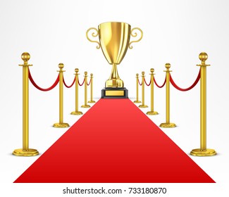 Gold cupfor the winner on a red carpet path