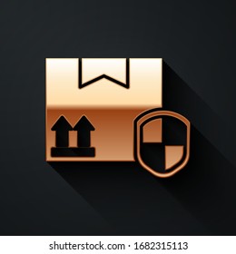 Gold Delivery pack security with shield icon isolated on black background. Delivery insurance. Insured cardboard boxes beyond the shield. Long shadow style. Vector Illustration