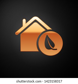 Gold Eco friendly house icon isolated on black background. Eco house with leaf. Vector Illustration
