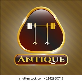  Gold emblem or badge with barbell on rack icon and Antique text inside