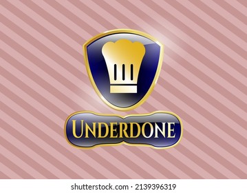 Gold emblem or badge with chef hat icon and Underdone text inside
