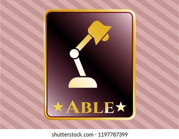  Gold emblem or badge with desk lamp icon and Able text inside