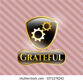  Gold emblem or badge with gear, team work icon and Grateful text inside