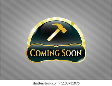  Gold emblem or badge with hammer icon and Coming Soon text inside