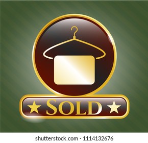   Gold emblem or badge with hanger with towel icon and Sold text inside