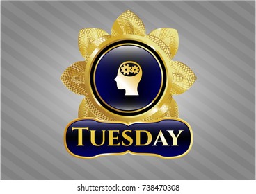  Gold emblem or badge with head with gears inside icon and Tuesday text inside