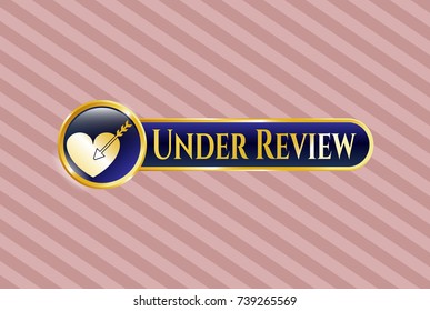 Gold emblem or badge with love icon and Under Review text inside