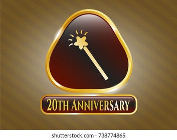  Gold emblem or badge with magic stick icon and 20th Anniversary text inside