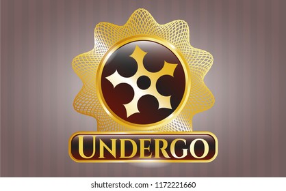  Gold emblem or badge with ninja star icon and Undergo text inside