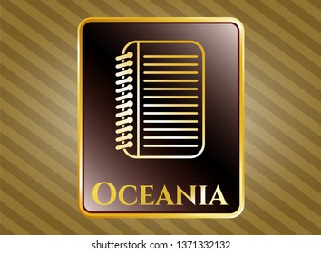  Gold emblem or badge with note book icon and Oceania text inside