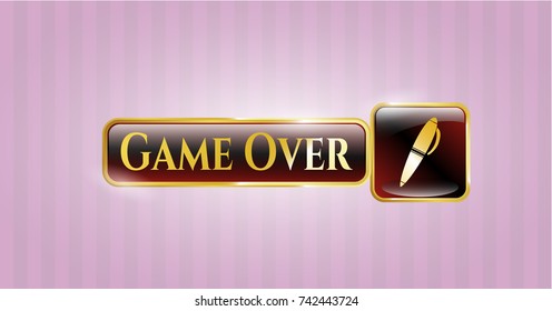 Gold emblem or badge with pen icon and Game Over text inside