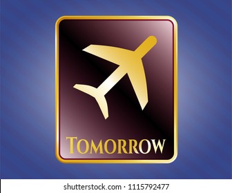  Gold emblem or badge with plane icon and Tomorrow text inside