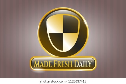  Gold emblem or badge with shield, safety icon and Made Fresh Daily text inside