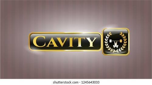  Gold emblem or badge with weightlifting inside of crown icon and Cavity text inside