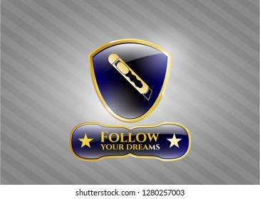  Gold emblem with cutter icon and Follow your dreams text inside