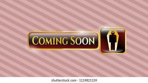  Gold emblem with dead man in his coffin icon and Coming Soon text inside
