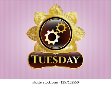  Gold emblem with gear, team work icon and Tuesday text inside