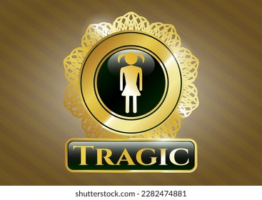 Gold emblem with girl icon and Tragic text inside