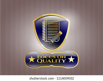  Gold emblem with notebook with pencil icon and Focus on Quality text inside
