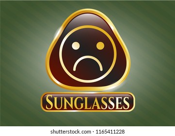  Gold emblem with sad face icon and Sunglasses text inside