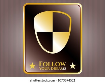 Gold emblem with shield, safety icon and Follow your dreams text inside Gold emblem with shield, safety icon and Follow your dreams text inside