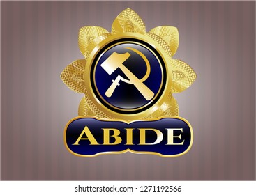  Gold emblem with sickle and hammer icon and Abide text inside