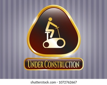   Gold emblem with stationary bike icon and Under Construction text inside