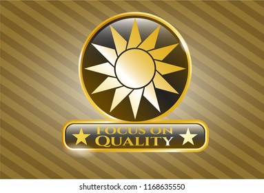  Gold emblem with sun icon and Focus on Quality text inside