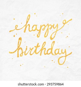 Gold foil Happy Birthday calligraphy script on crumpled paper