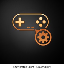 Gold Gamepad and gear icon isolated on black background. Adjusting app, service concept, setting options, maintenance, repair, fixing. Vector Illustration