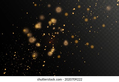 Gold glitter dust on a dark background with lens flares and light effects.