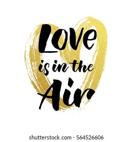 Gold glitter heart and Love is in the air text vector Valentines day greeting card with black calligraphy text on white background.