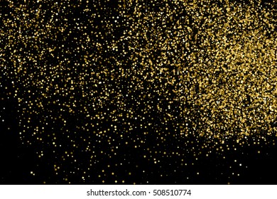 Gold glitter texture isolated on black. Celebratory background. Golden explosion of confetti. Vector illustration,eps 10.