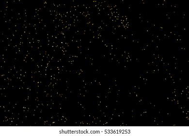 Gold glitter texture isolated on black. Amber particles color. Celebratory background. Golden explosion of confetti. Vector illustration,eps 10.